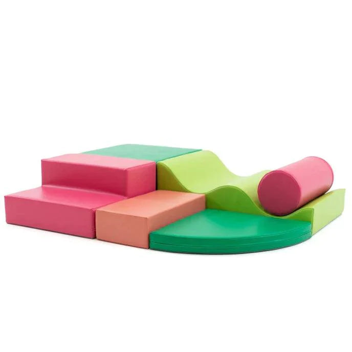 Pink and green soft play set made from various shapes like a square, cylinder, a wedge, and steps